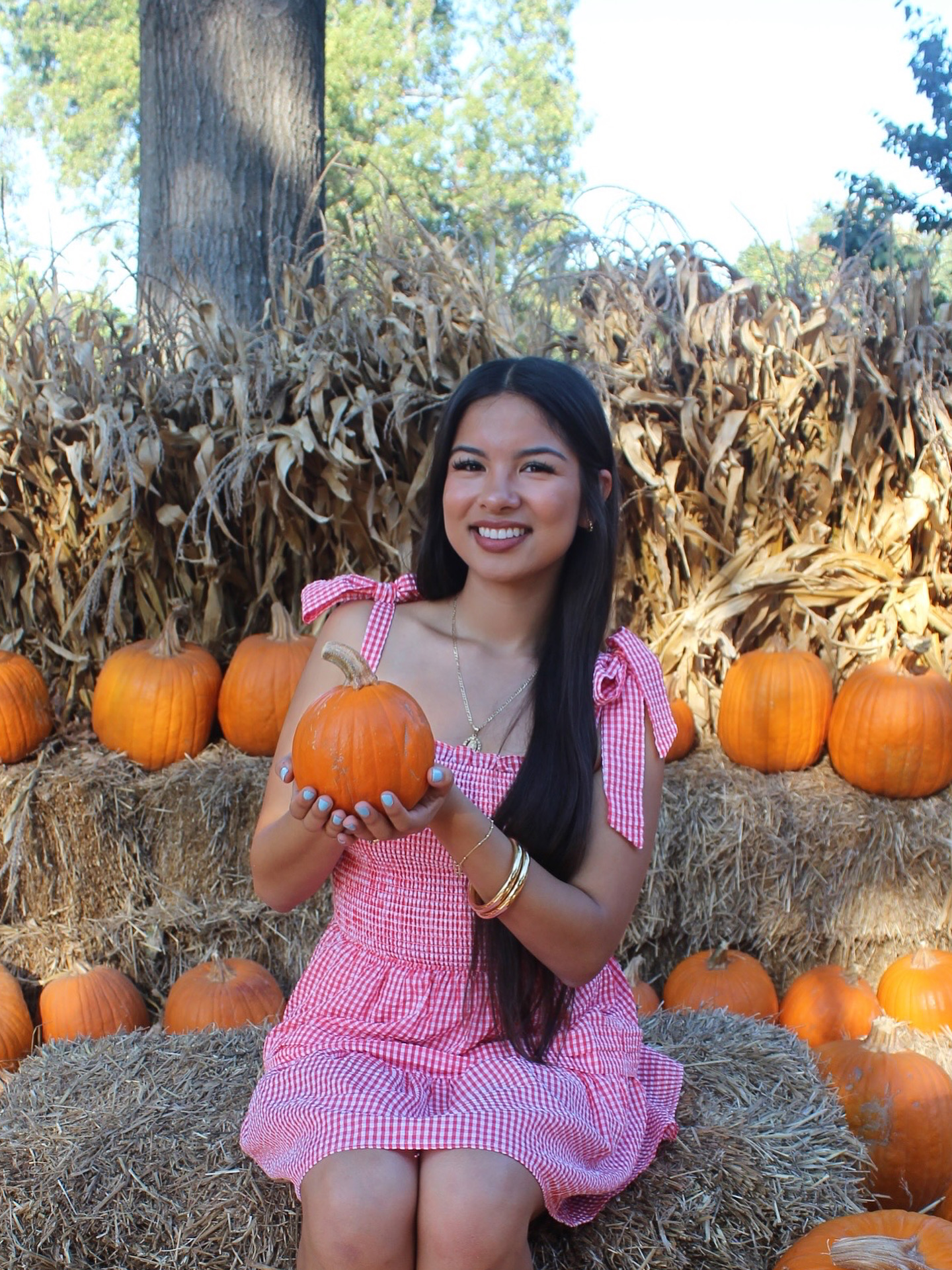 Briceida holding a pumpkin